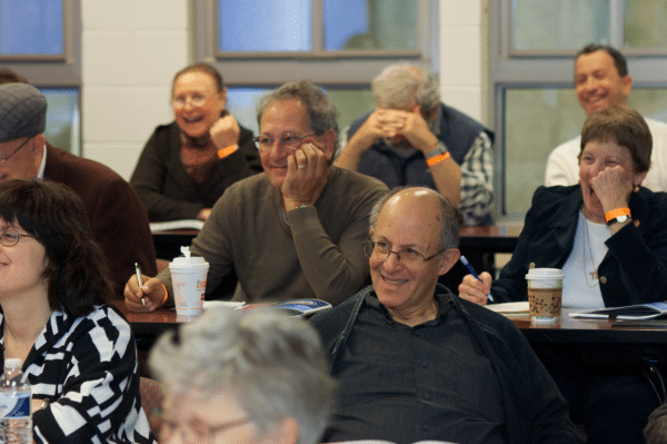 adults laughing at a learning session
