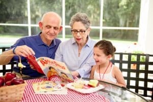 girl with grandparents reading a Rosh Hashanah story