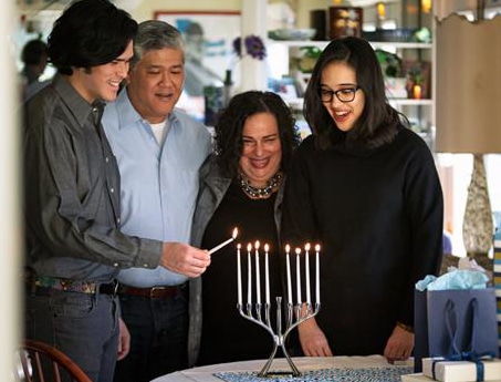 Multi Cultural Family Lighting Chanukah Menorah